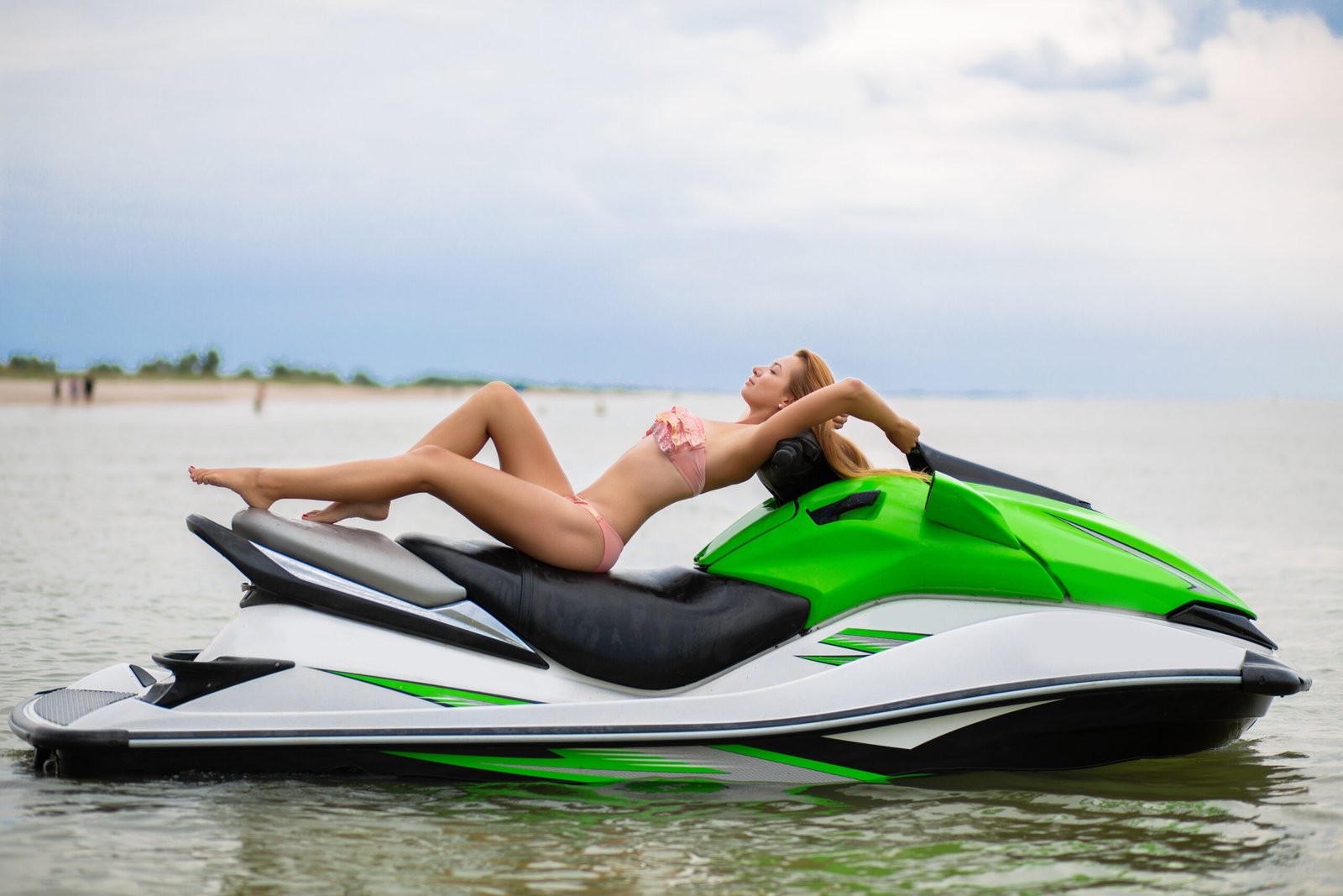 sexy woman in bikini on water scooter in sea summer style